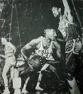 A stonewall defense by the name of Bill Russell keeps Philadelphia 76ers' Wilt Chamberlain at bay.