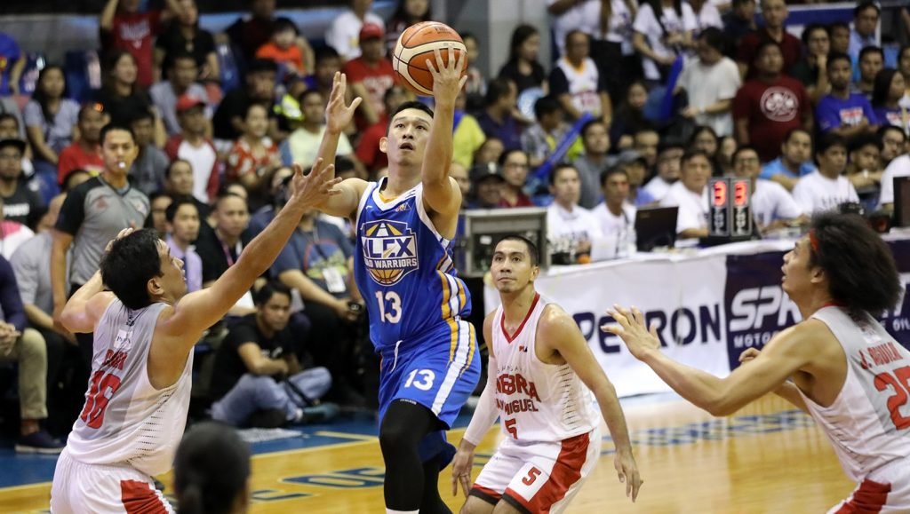 Kyles Lao of the NLEX Road Warriors lays it in against Ginebra defenders, Jeff Chan and Japeth Aguilar. [photo: PBA Images]