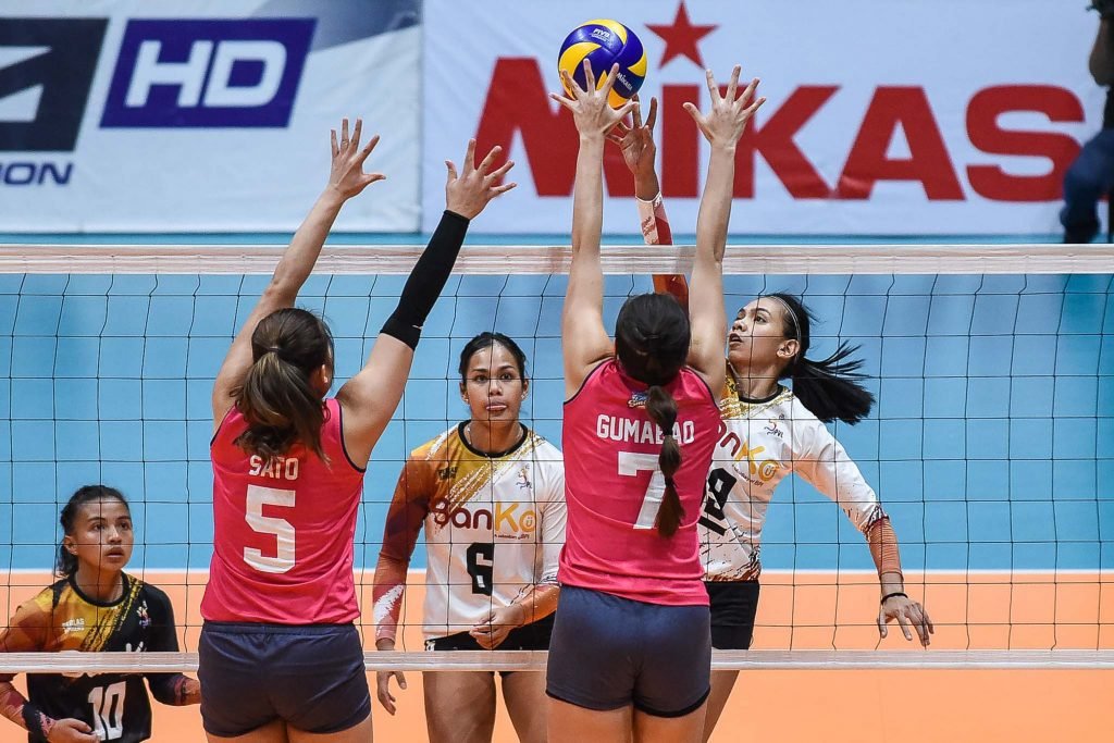 BanKo-Perlas’ Nicole Tiamzon challenges Creamline’s RIsa Sato and Michele Gumabao during their PVL Open match.