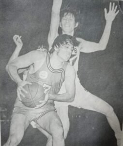 Meralco's bull-strong Sonny Jaworski bulldozes his way past Yutivo's Roy Deles in a MICAA game in the early 1970s.