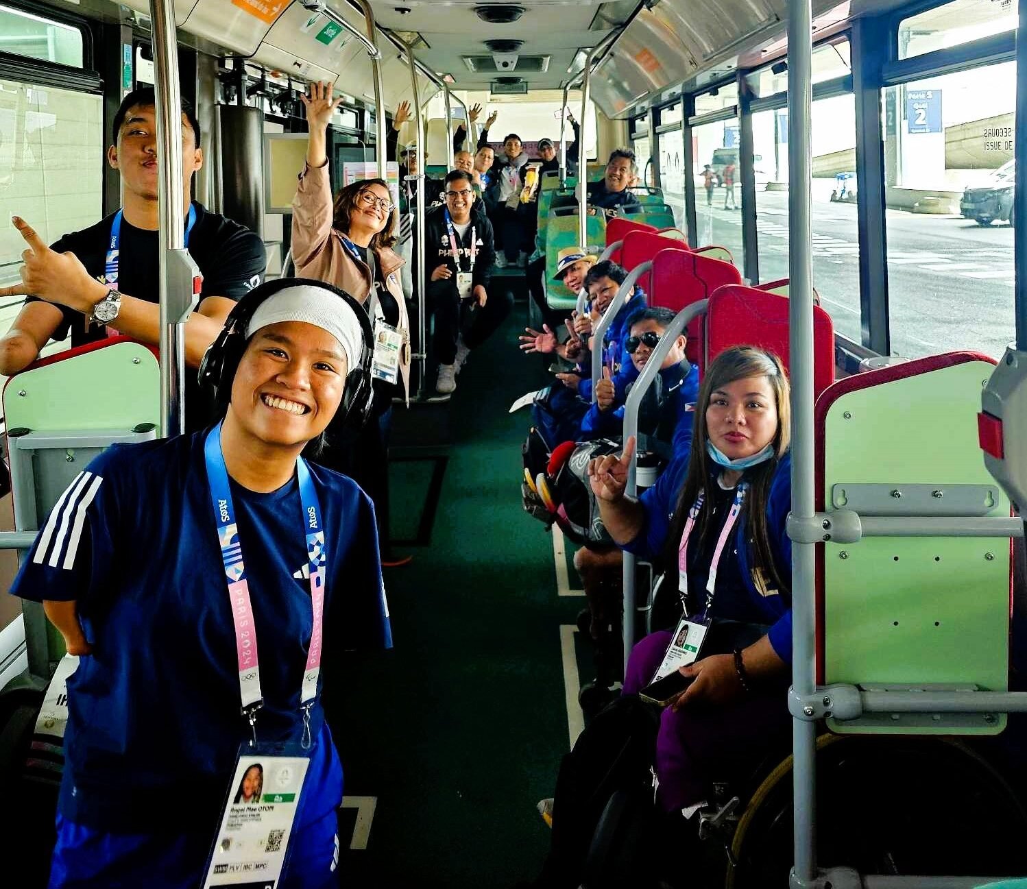 The Philippine Paralympic Games contingent members smile as they are shuttled to the Paralympic Village in Paris. In front are (from left) taekwondo jin Allain Ganapin (partly covered), swimmer Angel Mae Otom and wheelchair thrower Cendy Asusano.