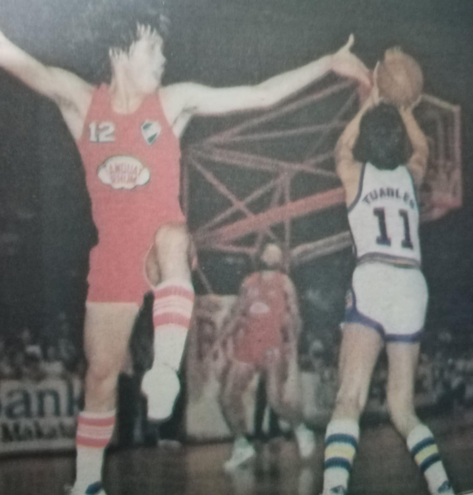 Toyota's Arnie Tuadles has all day to shoot as Tanduay Rhum's Rey Lazaro flies past him in 1981 PBA action.