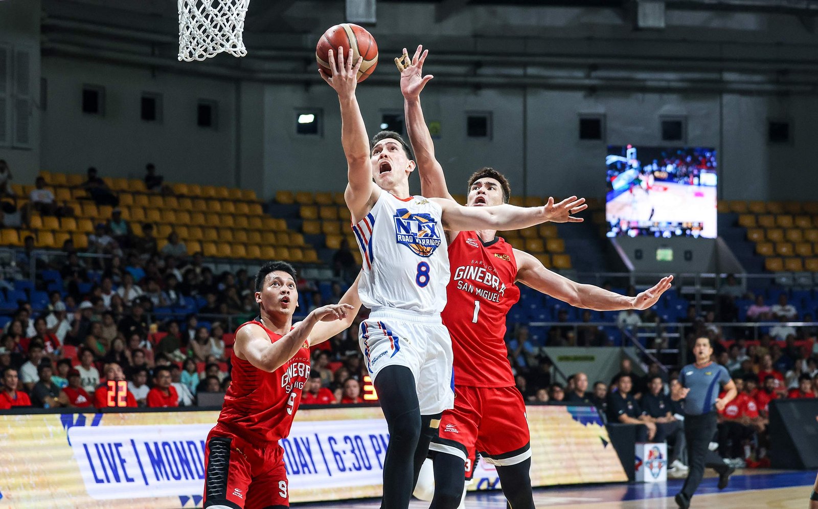 Robert Bolick powers through Ginebra defenders for a clutch layup. [PBA Images]