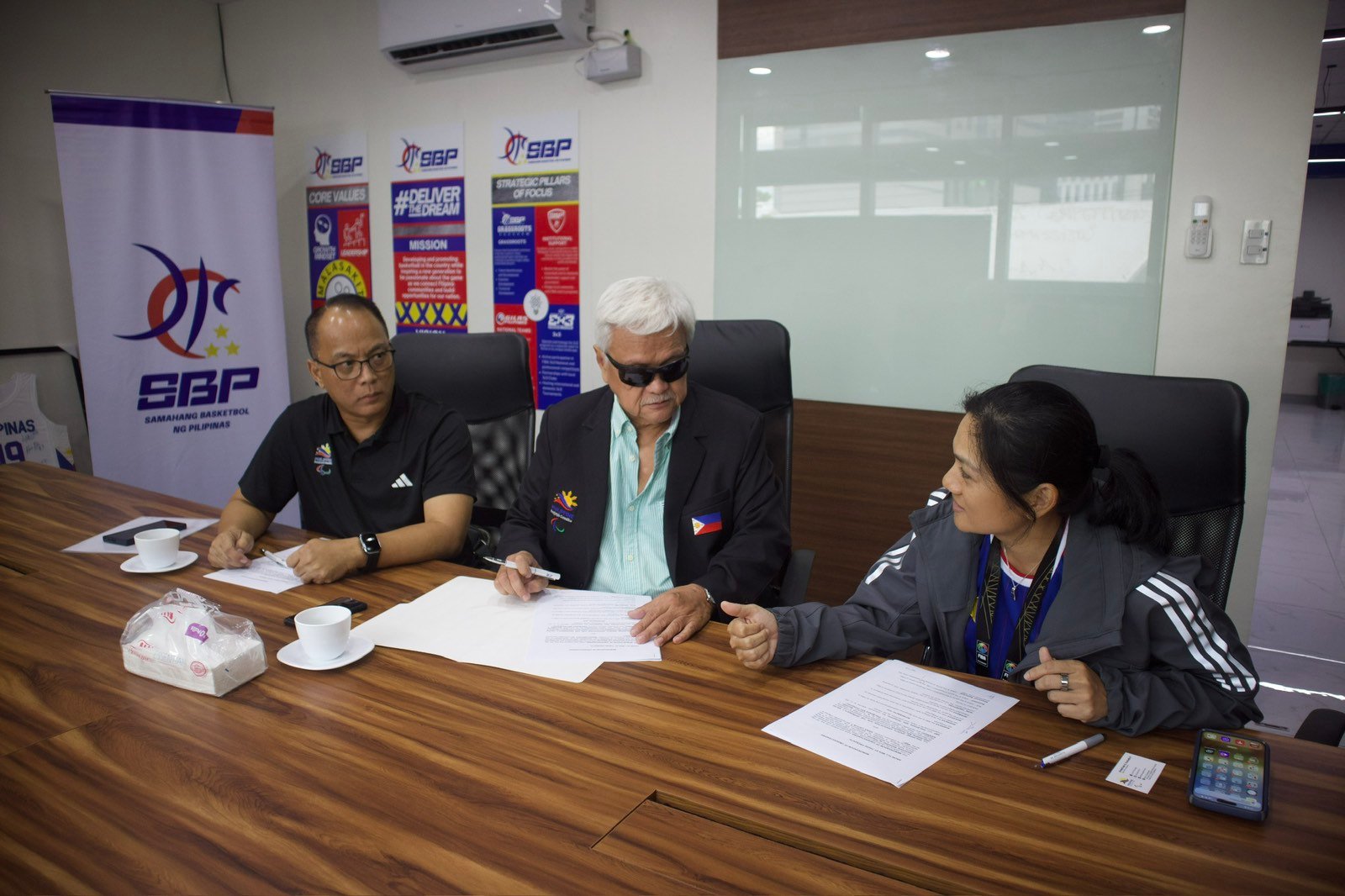 SBP Executive Director Erika Dy and PHILSPADA President Michael I. Barredo sign an MOU to promote wheelchair basketball in the Philippines.