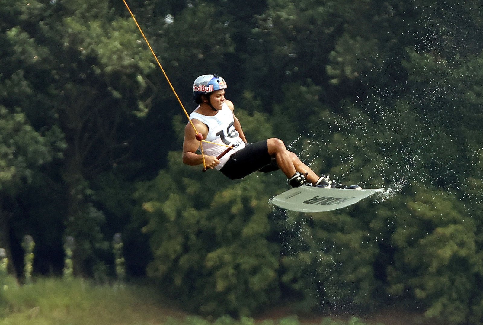 Raph Trinidad performing an aerial trick during the cable men’s wakeboard finals.