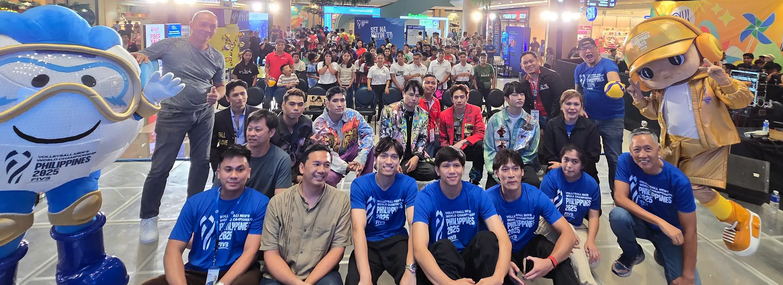 LAOAG City Vice Mayor Laoag City Vice Mayor Carlos Fariñas (brown polo) and PNVF Charter Member Faivo Bartolome (seated right), with Cignal HD Spikers Josh Umandal, JM Ronquillo and Vince Malinao and members of the group Ist.One are joined by mascots KidLat and Hataw at the SM City-Laoag. [PNVF Photo]