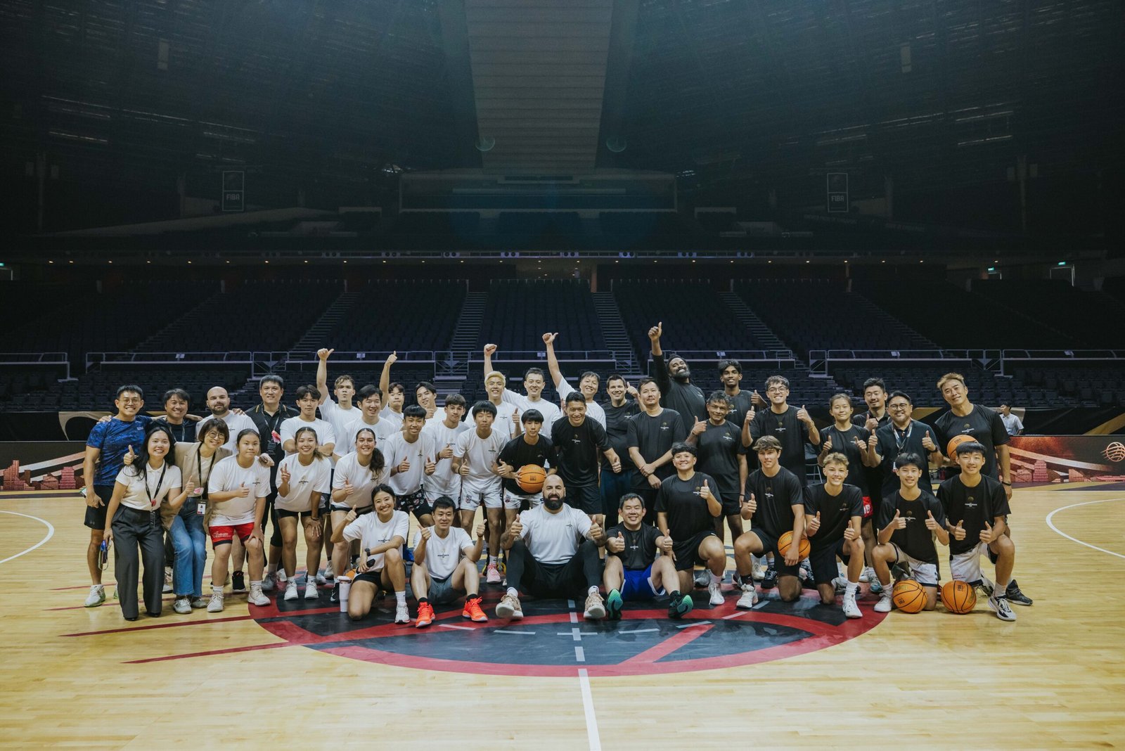 Players from Singapore’s schools and academies share the court with national stars during the FIBA Intercontinental Cup pro-am game. [photo credit: Singapore Sports Hub]