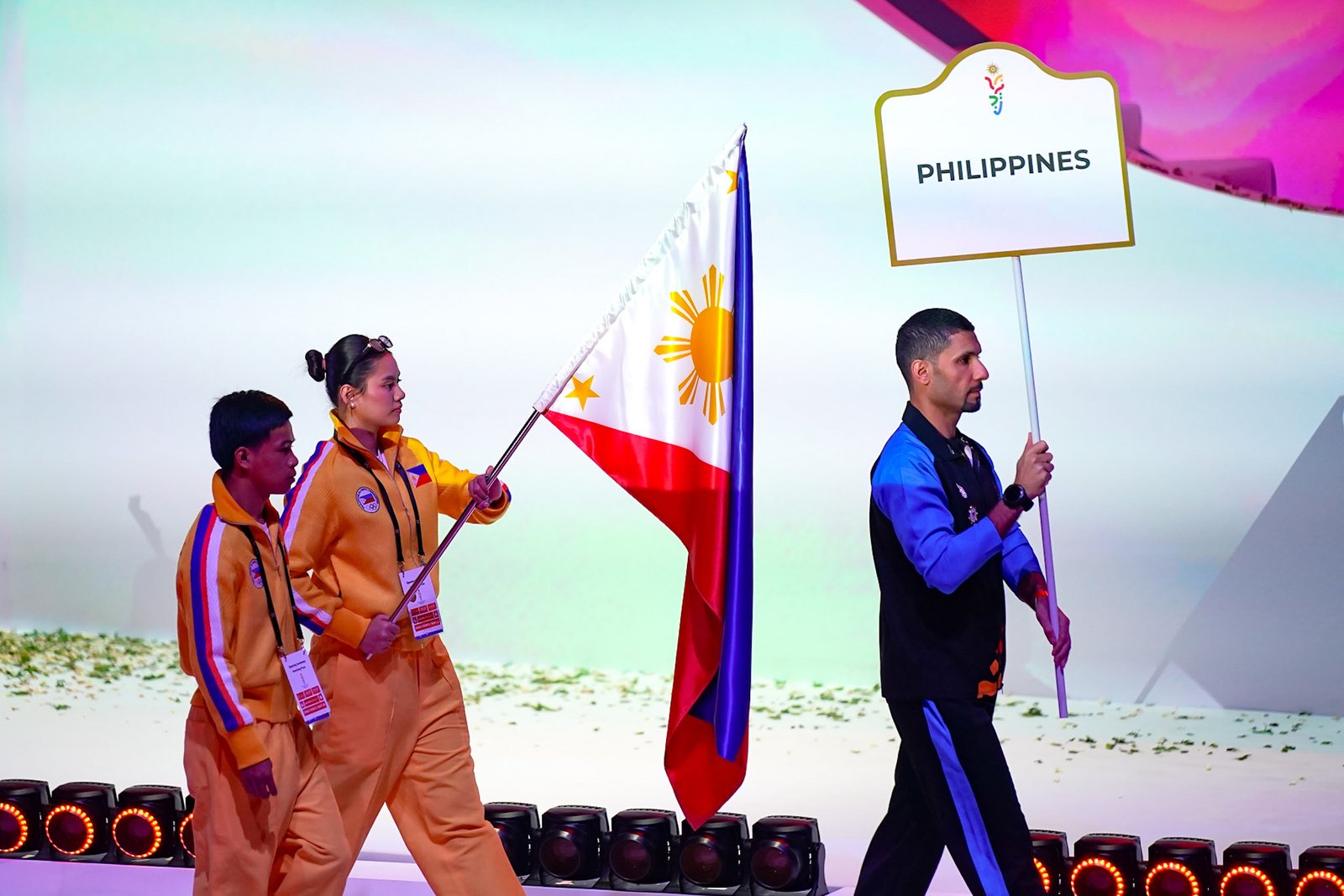 Boxer Leo Mhar Lobrido and Volleybelle Harlyn Serneche carry the Philippine Flag during the 3rd Asian Youth Games opening ceremony.  [POC photo]