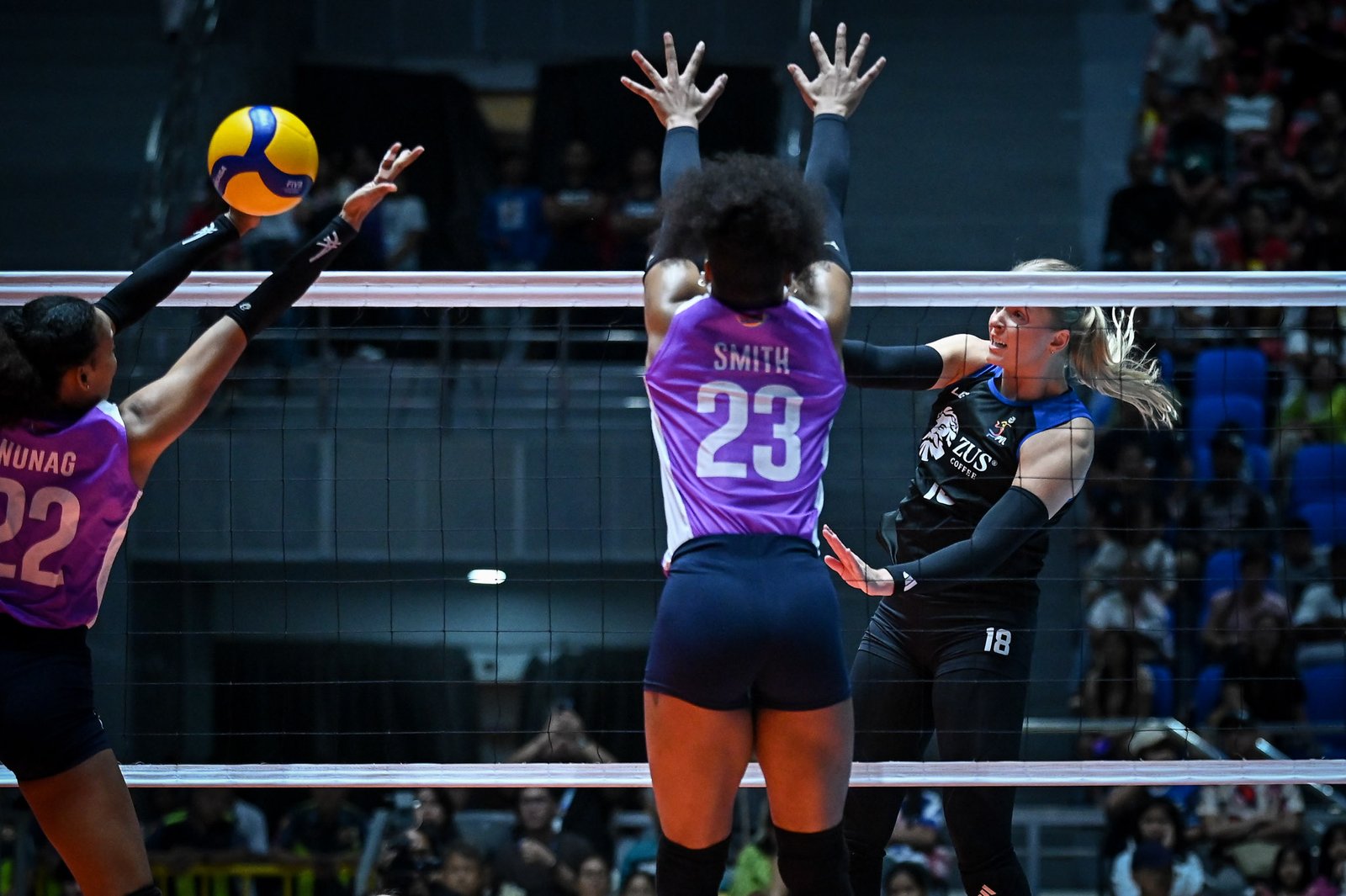 Anna DeBeer powers a spike past Choco Mucho defenders. [PVL Images]