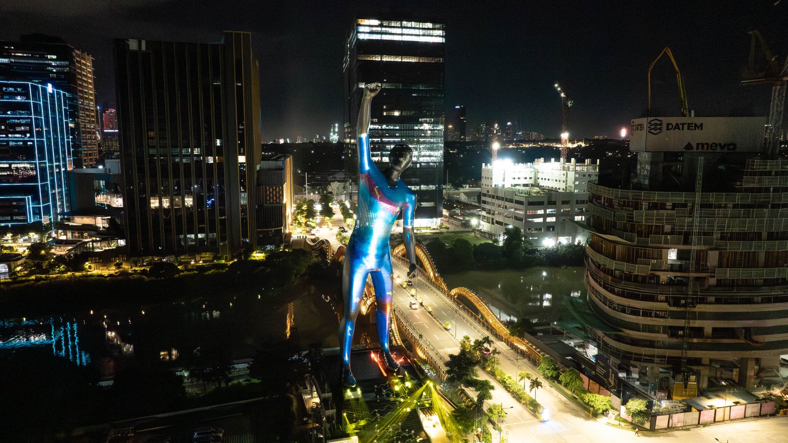 The Victor statue lights up in blue to mark the national kit unveiling.