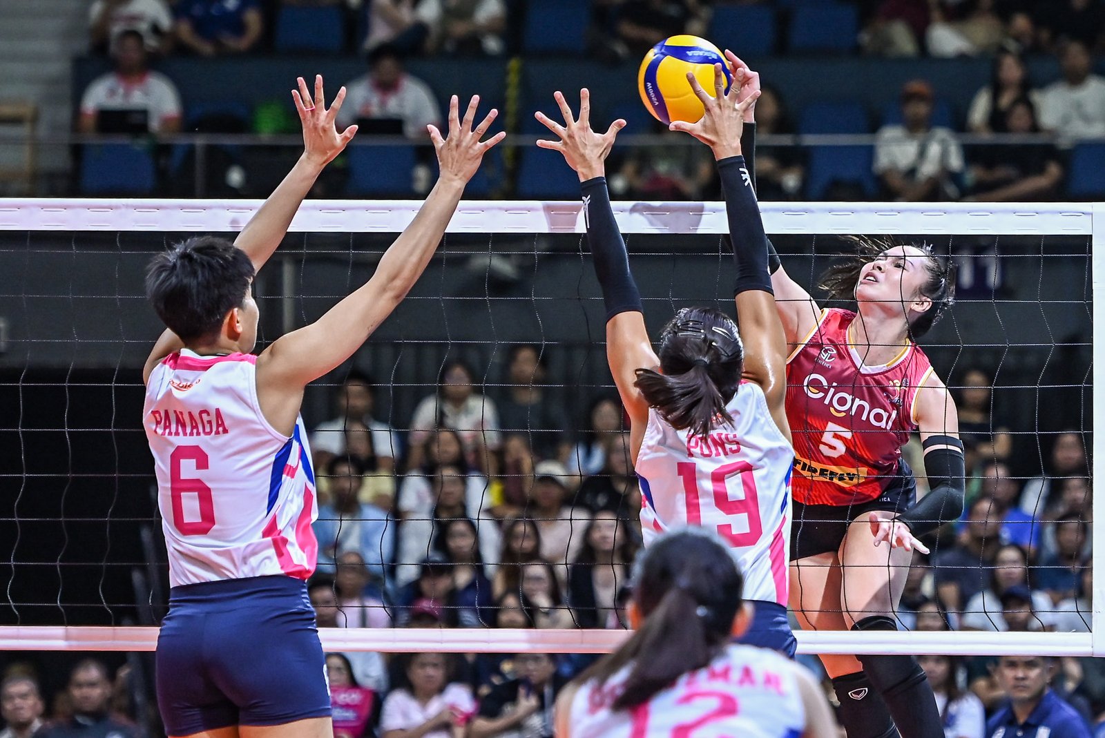 Vanie Gandler attacks through the Creamline block. [PVL Images]