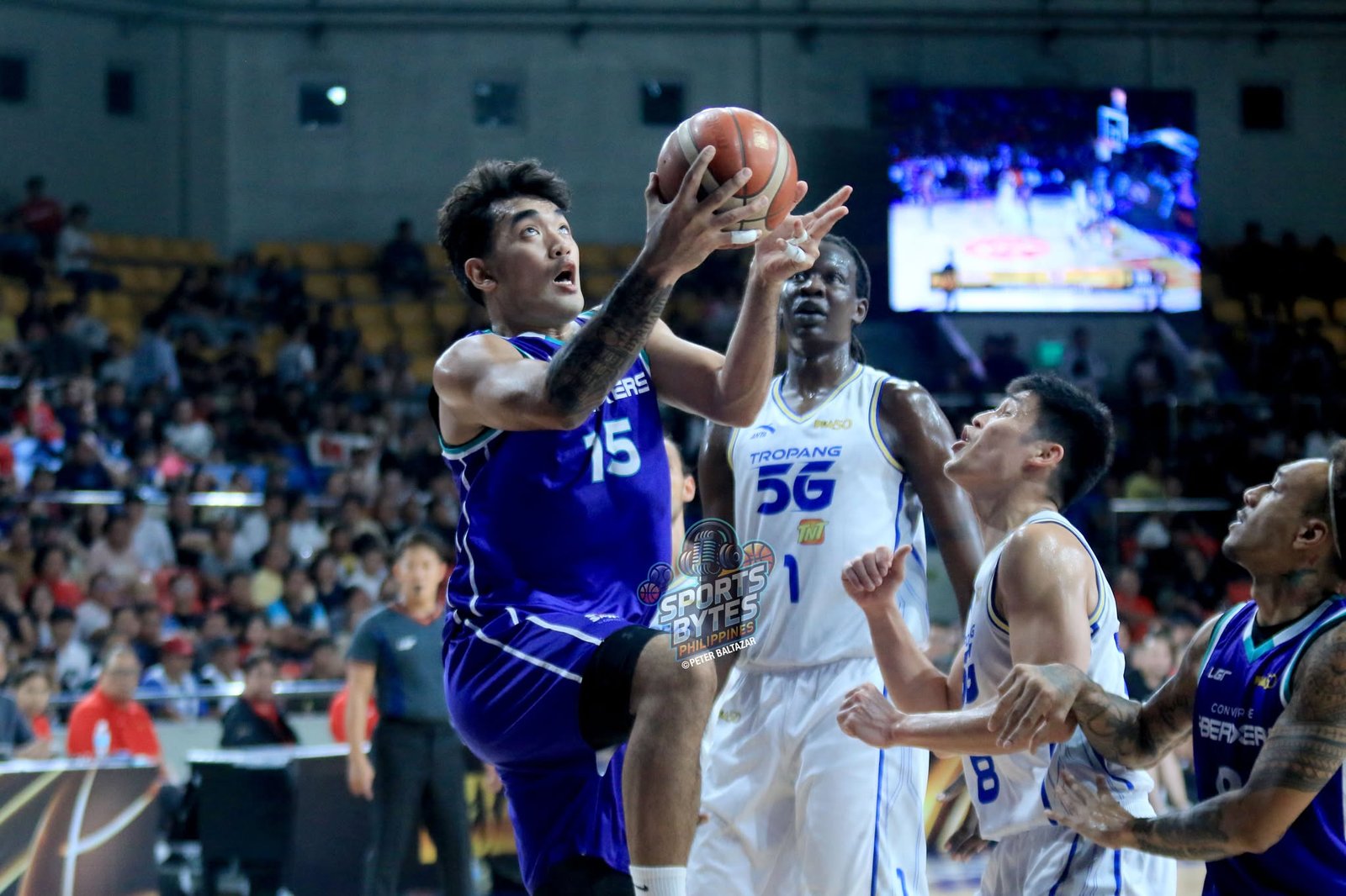 Justin Arana leads Converge past TNT in a must-win game to keep their postseason dreams alive. [photo credit: Peter Baltazar]