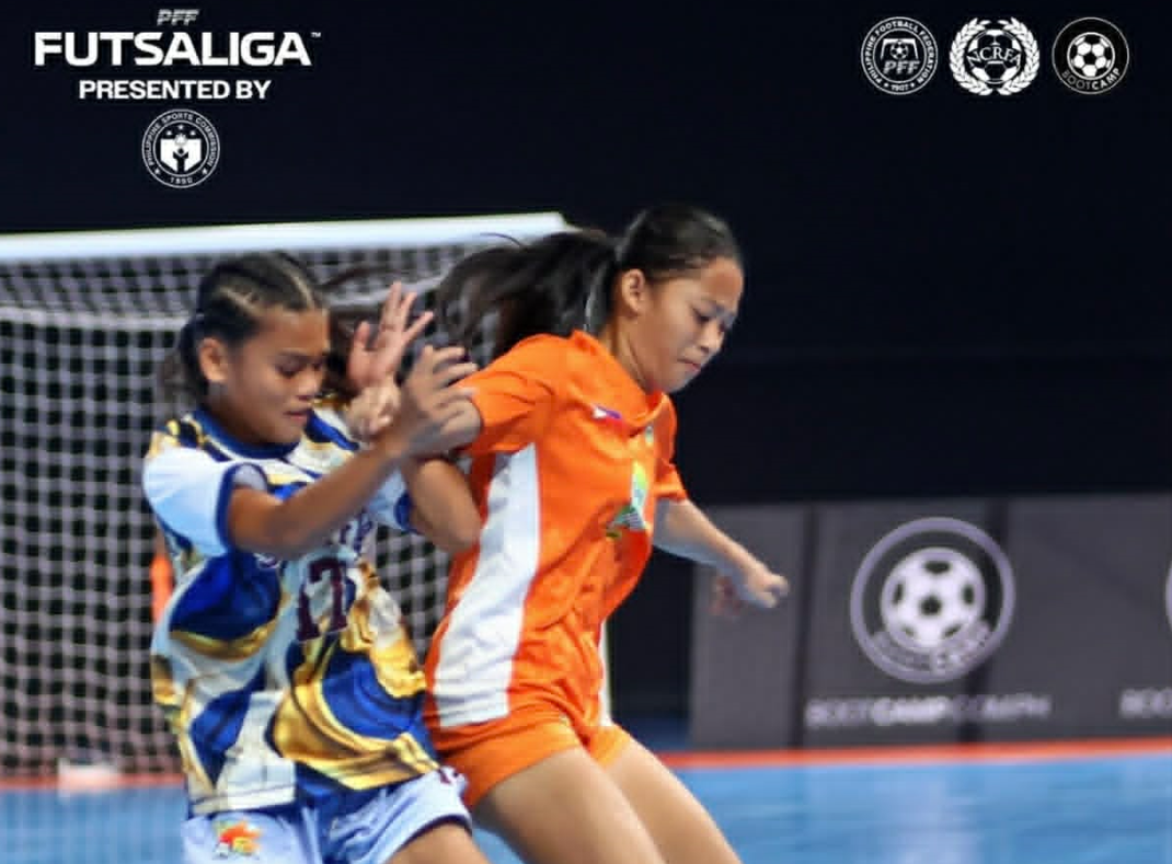 Feona Maquinay (right) of league leading Beach Hut takes control of the ball against Star FC's Maria Veronica Cruz (left) .