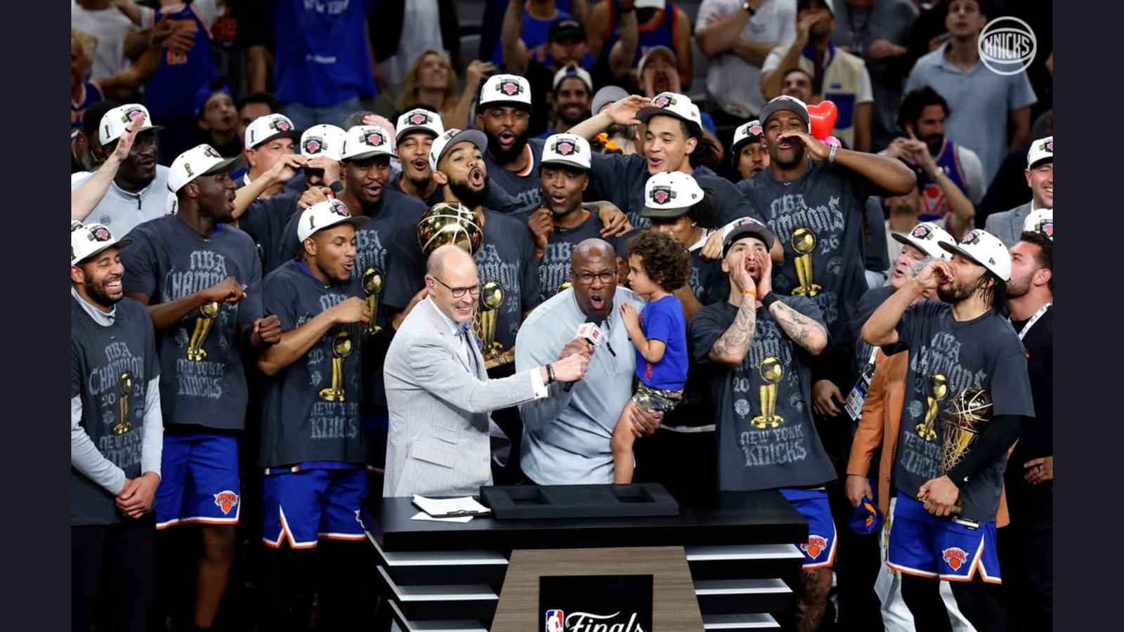 New York Knicks players pose with the Larry O'Brien Trophy after winning the NBA Finals. [NYKnicks Instagram]