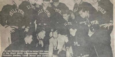 Members of the Philippine national team to the 1954 World games listen attentively to head coach Hetminio Silva during a huddle.