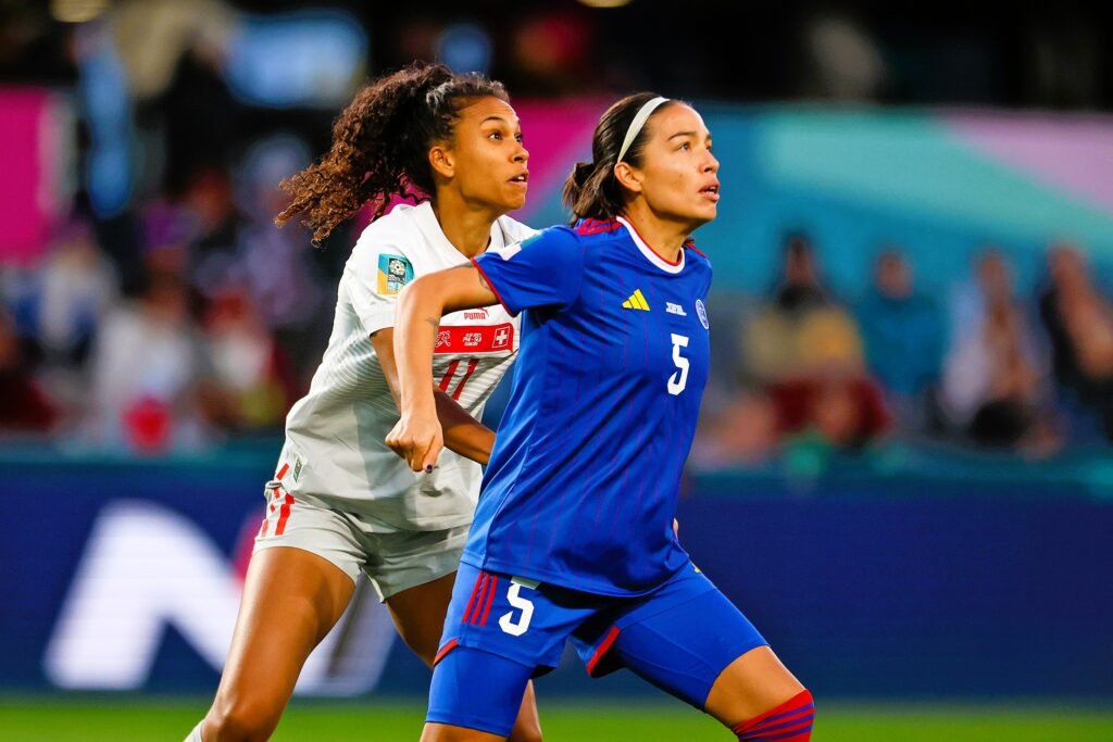 Skipper Hali Long (right) tries to mark a Swiss player.