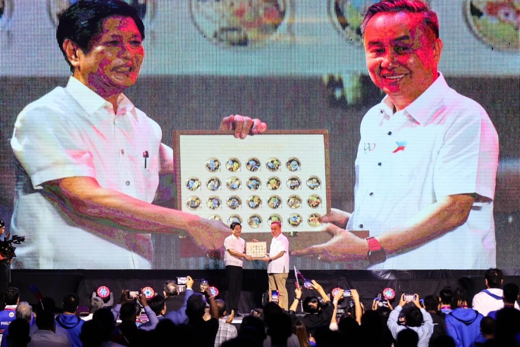 Philippine Olympic Committee president Rep. Abraham “Bambol” Tolentino (right) presents President Ferdinand R. Marcos a memorabilia from the 19th Asian Games in Hangzhou during the “Gabi ng Parangal at Pasasalamat Para sa Bayaning Atletang Pilipino” at the Rizal Memorial Coliseum on Wednesday. The memorabilia consists of 40 gold coins with the images of the 40 sports disciplines played in the Asian Games. [PSC media pool]