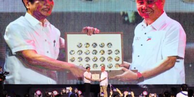 Philippine Olympic Committee president Rep. Abraham “Bambol” Tolentino (right) presents President Ferdinand R. Marcos a memorabilia from the 19th Asian Games in Hangzhou during the “Gabi ng Parangal at Pasasalamat Para sa Bayaning Atletang Pilipino” at the Rizal Memorial Coliseum on Wednesday. The memorabilia consists of 40 gold coins with the images of the 40 sports disciplines played in the Asian Games. [PSC media pool]