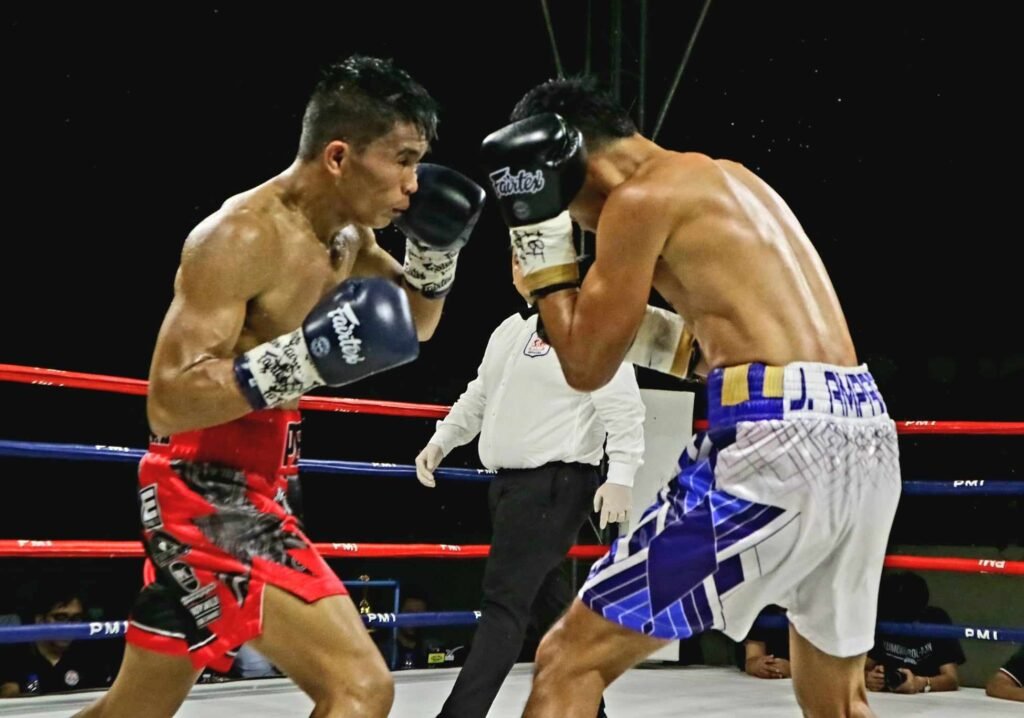 Pedro “Kid Pedro Heneral” Taduran and Jake "El Bambino" Amparo slug it out in the main event of the “Kumong Bol-anon XIII” boxing series on Thursday night, Dec. 28, at the Bohol Wisdom School Gym in Tagbilaran City, Bohol. (Calvin D. Cordova)