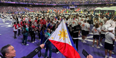 POC president Abraham “Bambol” Tolentino waves the country’s colors during the closing ceremony of the Paris 2024 Olympics last August. [POC photo]