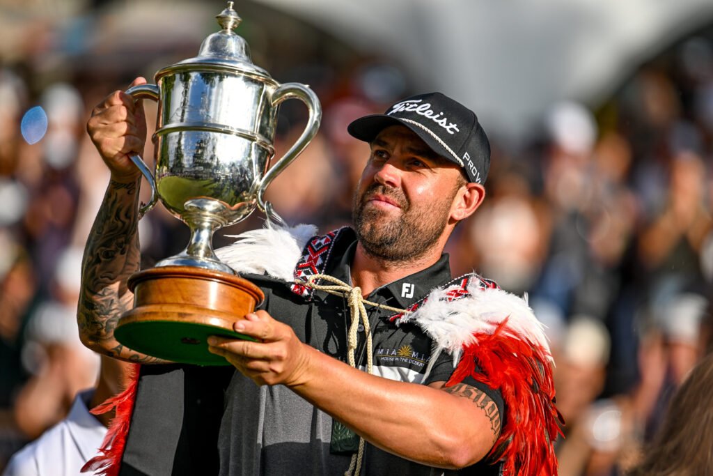 Ryan Peake lifts the Brodie Breeze Trophy after his stunning victory at the New Zealand Open. [photo credit: Steve McArthur/www.photosport.nz]