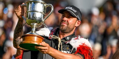 Ryan Peake lifts the Brodie Breeze Trophy after his stunning victory at the New Zealand Open. [photo credit: Steve McArthur/www.photosport.nz]