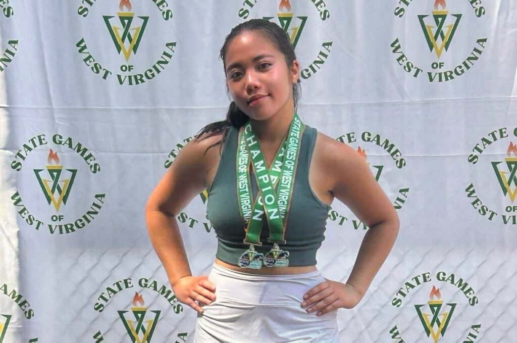 Saphire shows off her two gold medals after a dominant weekend in Huntington.