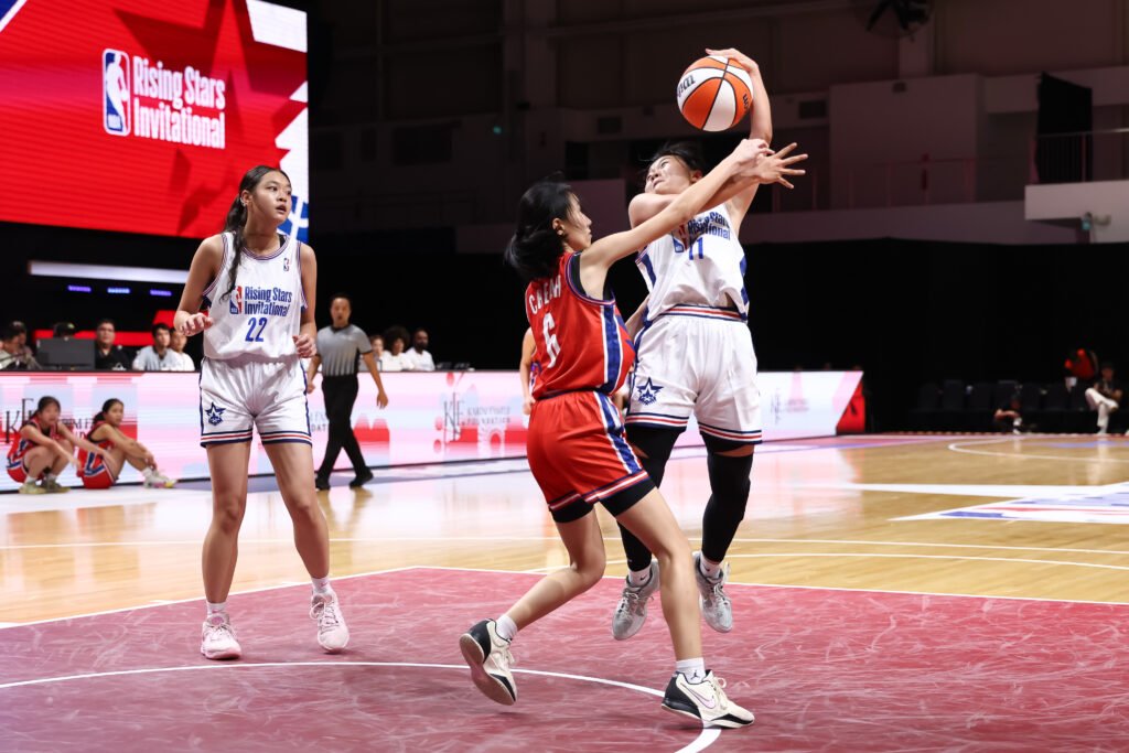Kong Qian Ya of Hwa Chong drives through the defense in a hard-fought matchup. [photo credit: NBA Rising Stars Invitational]
