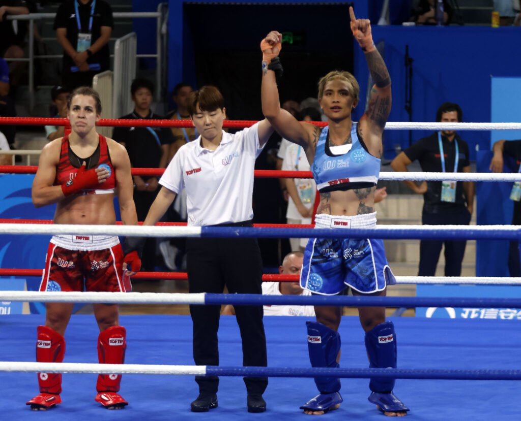 Hergie Bacyadan celebrates her quarterfinal win at the World Games kickboxing tournament in Chengdu.