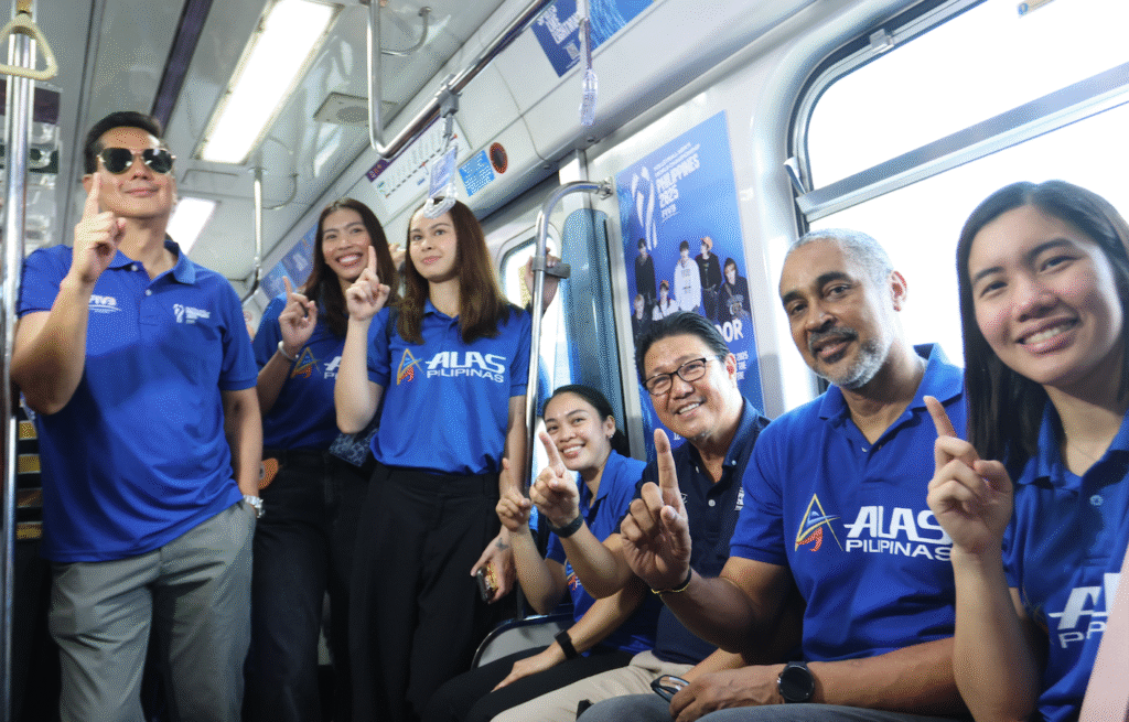 JIA MORADO-DE GUZMAN (right) makes the No. 1 sign on board a specially-designed LRT-2 train with (from left) Philippine National Volleyball Federation (PNVF) secretary-general Donaldo Caringal, Alleiah Malaluan, Vanie Gandler, Dawn Macandili-Catindig, PNVF president Ramon “Tats” Suzara and Alas Women head coach Jorge Edson Souza de Brito.
