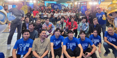 LAOAG City Vice Mayor Laoag City Vice Mayor Carlos Fariñas (brown polo) and PNVF Charter Member Faivo Bartolome (seated right), with Cignal HD Spikers Josh Umandal, JM Ronquillo and Vince Malinao and members of the group Ist.One are joined by mascots KidLat and Hataw at the SM City-Laoag. [PNVF Photo]