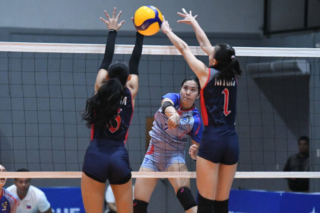 Arellano’s Laika Tudlasan unleashes a spike against Letran defenders. [PVL Images]