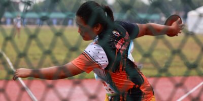 Bago City’s Divine Pablito competes in the girls’ discus throw under rainy conditions. [PR photo]