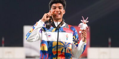 Wangkay proudly holds his gold medal after his 200m victory. [POC photo]