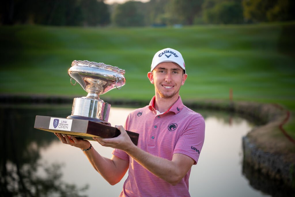 Tom McKibbin lifts the Hong Kong Open trophy after a wire-to-wire victory. [Asian Tour photo]