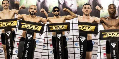 Fighters pose on stage as the historic BRAVE Combat Federation 100 card becomes official.