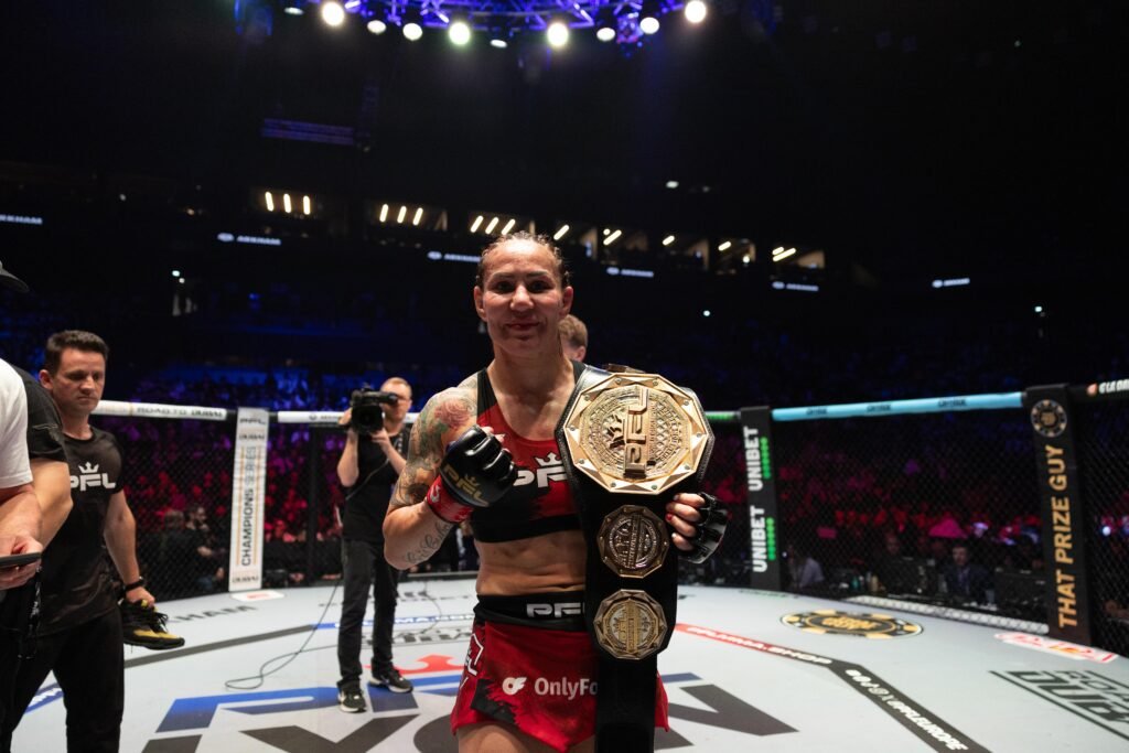 Cris Cyborg poses with the PFL Women’s Featherweight World Title at the LDLC Arena. [PFL photo]