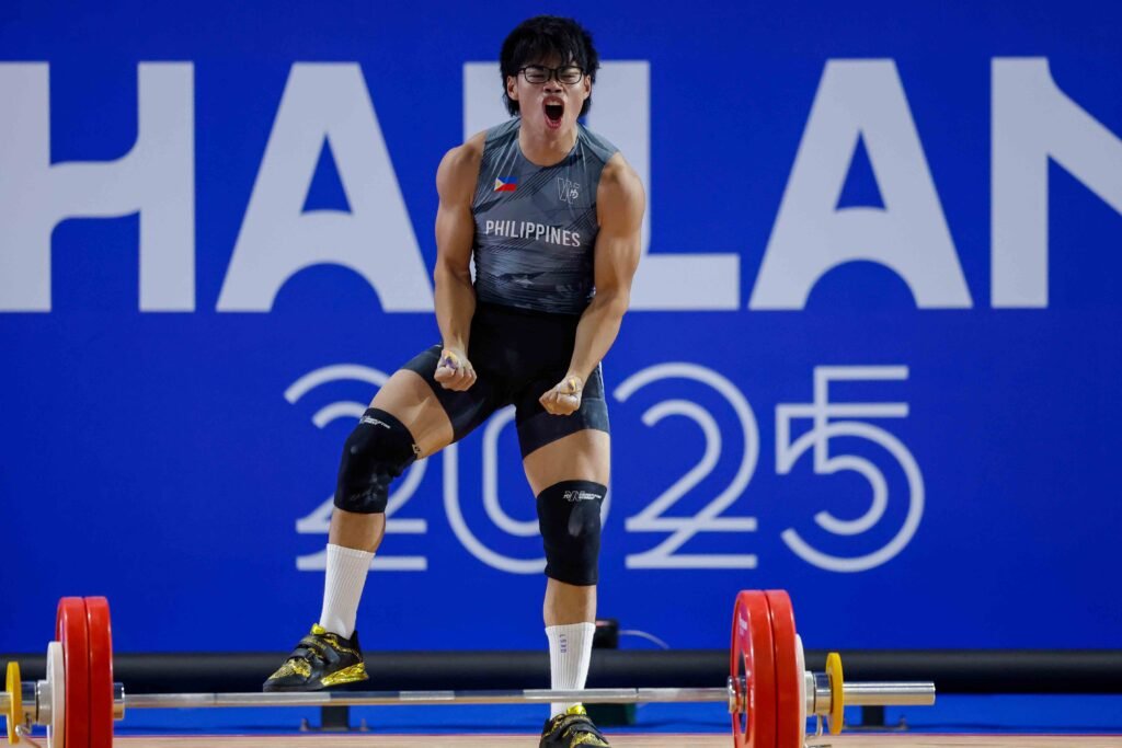 Delos Santos celebrates after setting a new world juniors record in the clean and jerk. [POC Media Pool]