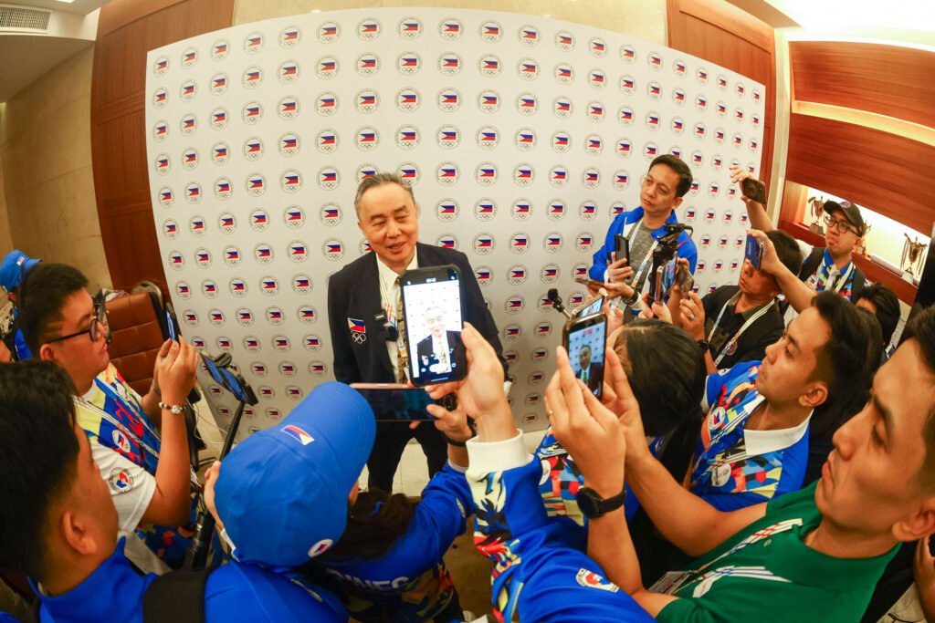 POC president Abraham Tolentino discusses last-minute changes to the delegation lineup. [POC Media pool]