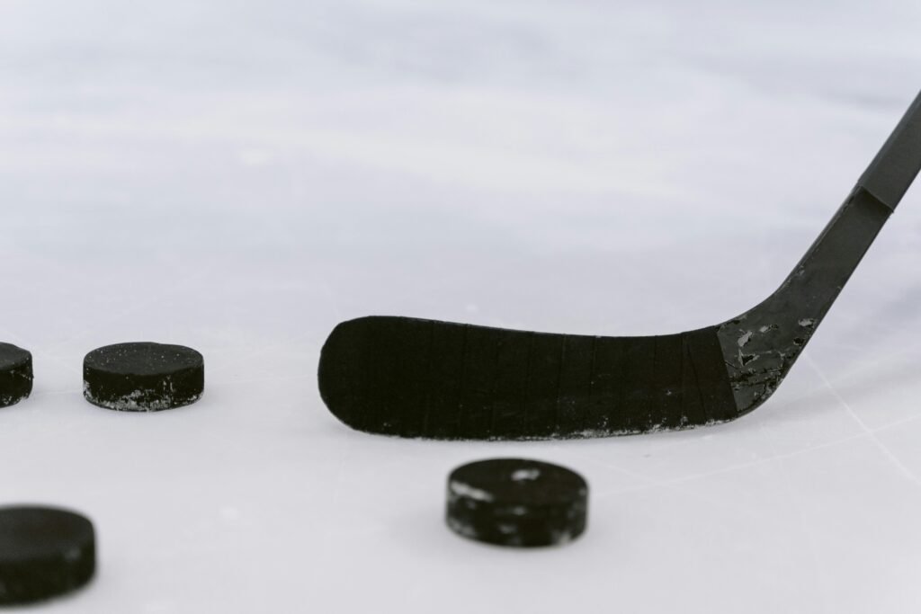 hockey representation image [Photo by Tima Miroshnichenko from Pexels: https://www.pexels.com/photo/close-up-shot-of-a-hockey-puck-and-hockey-stick-6847470/]