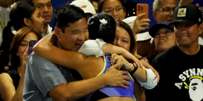 Alex Eala's parents, Mike Eala and Rizza-Maniego Eala, warmly embrace their daughter after her 4-6, 4-6 women's singles quarterfinal loss to Colombia's Camila Osorio in the Philippine Women's Open last Thursday night. [PSC photo]