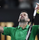Djokovic shrugs off fall to notch record 400th grand slam win