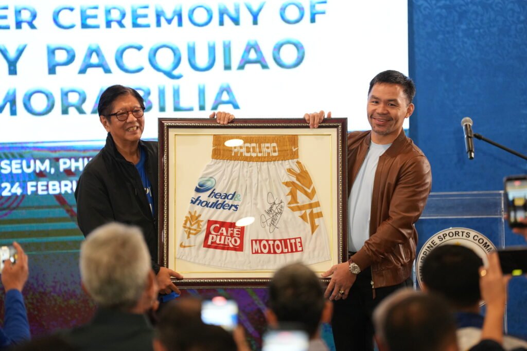 Manny Pacquiao hands over his fight trunks to President Ferdinand Marcos Jr. at the Philippine Sports Museum. [PSC photo]