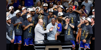 New York Knicks players pose with the Larry O'Brien Trophy after winning the NBA Finals. [NYKnicks Instagram]