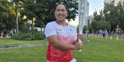 Hidilyn Diaz-Naranjo carries the torch during the relay leading to the Aichi-Nagoya Asian Games. [POC Media Pool]